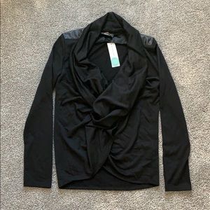 Black top with faux leather trim on back shoulders